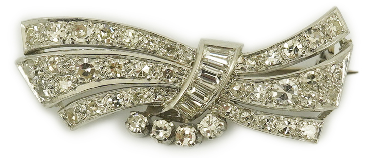 A mid 20th century platinum? and diamond cluster scroll brooch